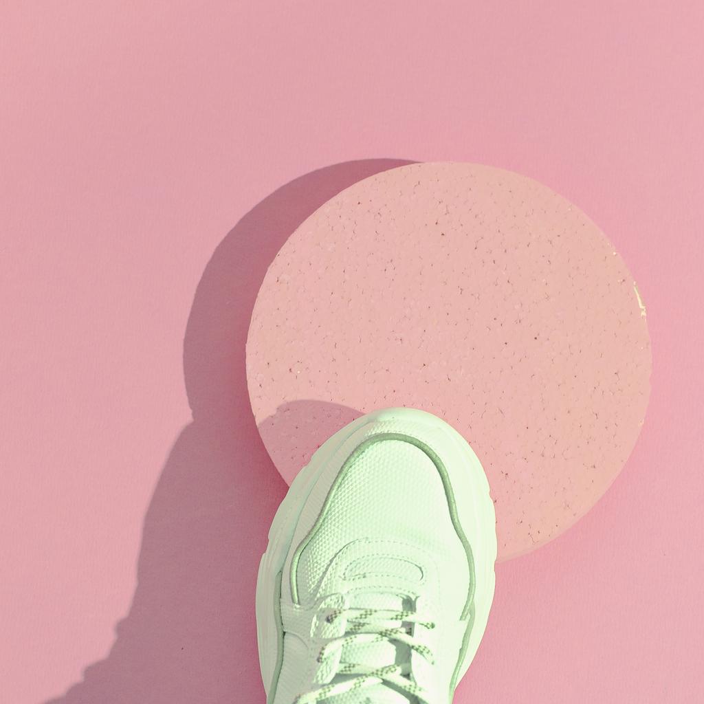 Minimal still life art. Fashion sport shoes concept. Pink colours trends. Stylish white sneakers by EvgeniyaPorechenskaya