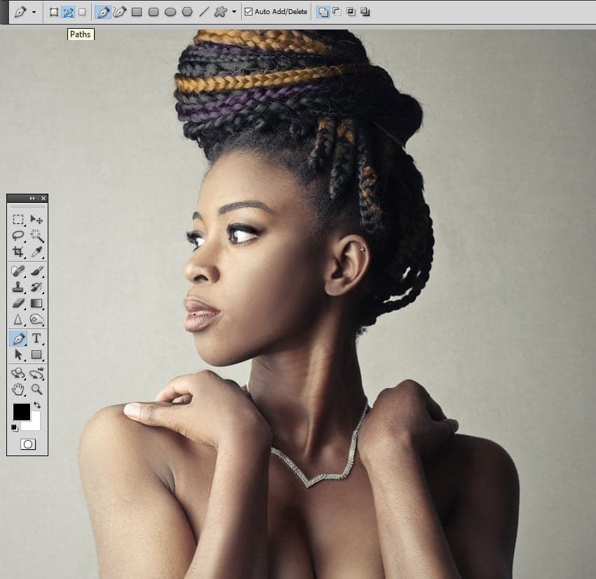 Use the Pen Tool to trace the contour of the woman. Make sure you have the Paths option selected.
